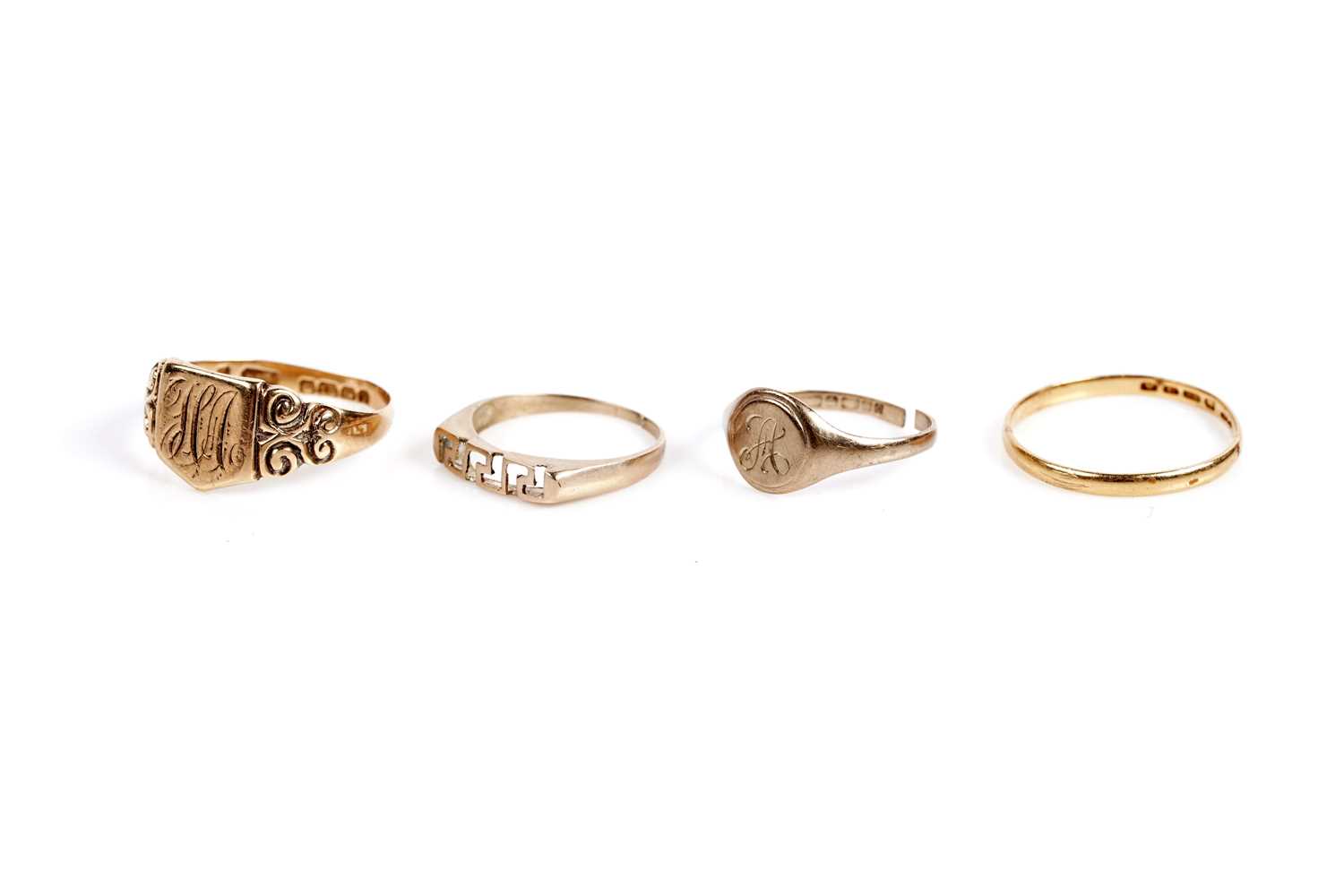 Lot 595 - A 22ct gold wedding band; two gold signet rings; and another ring