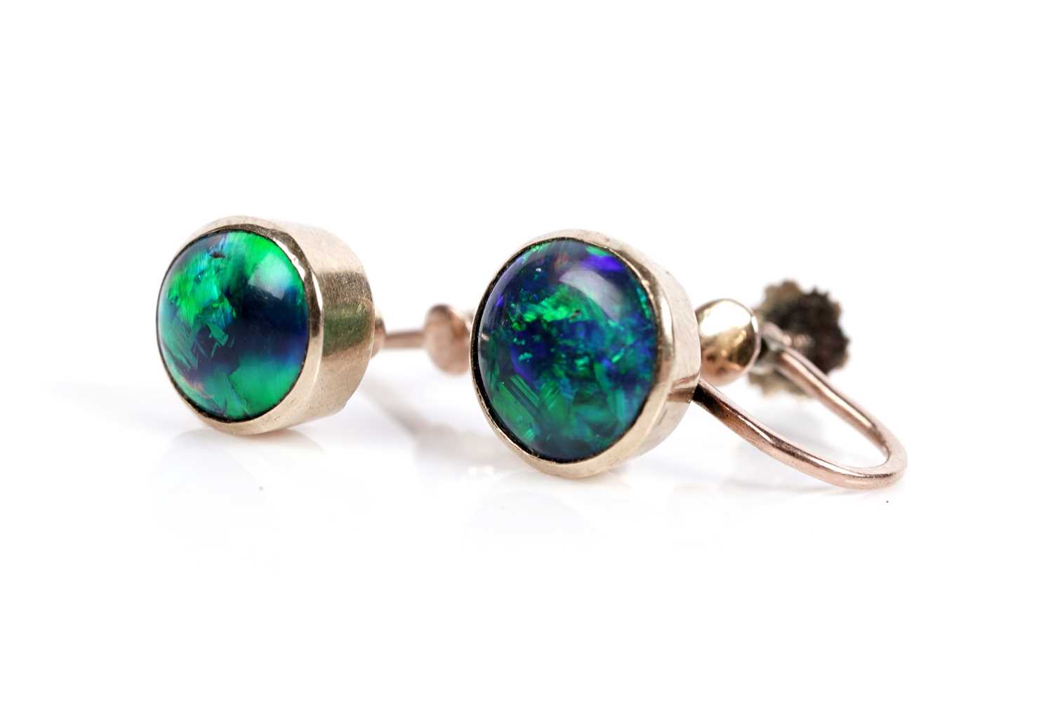Lot 664 - A pair of black opal cabochon screwback earrings