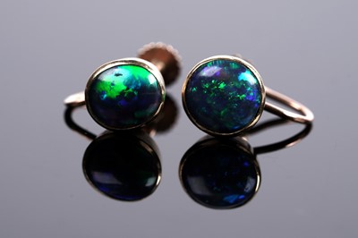 Lot 664 - A pair of black opal cabochon screwback earrings