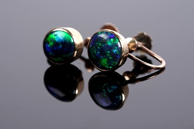 Lot 664 - A pair of black opal cabochon screwback earrings