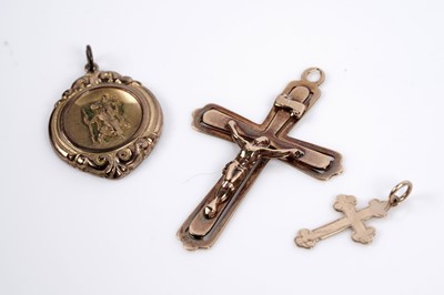 Lot 650 - Two gold crucifix pendants; and a St Christopher pendant