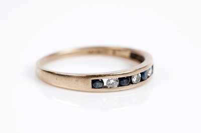 Lot 652 - A sapphire and diamond half eternity ring