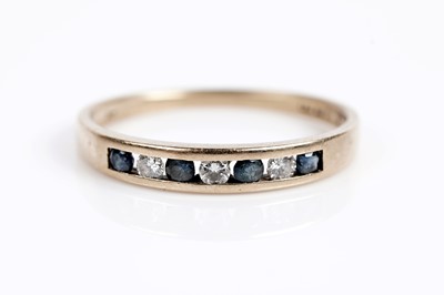 Lot 652 - A sapphire and diamond half eternity ring