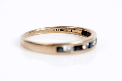 Lot 652 - A sapphire and diamond half eternity ring