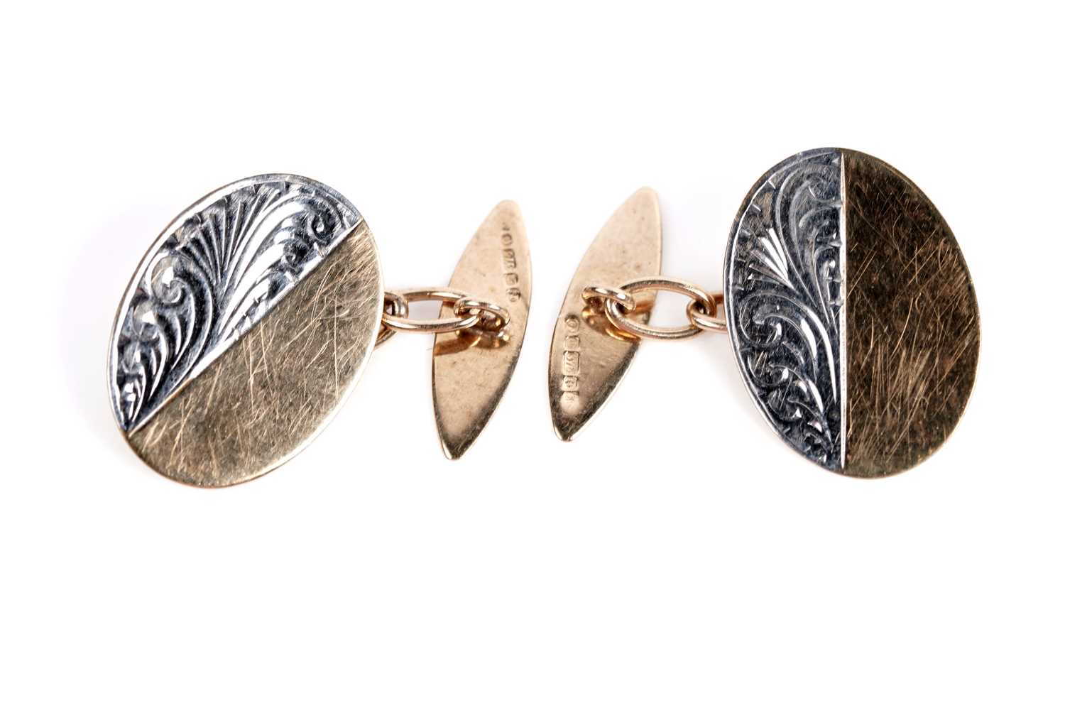 Lot 677 - A pair of bi-colour gold cufflinks