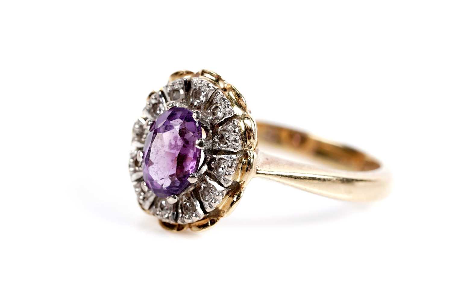Lot 621 - An amethyst and diamond cluster dress ring
