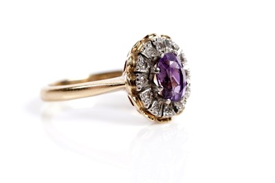 Lot 621 - An amethyst and diamond cluster dress ring