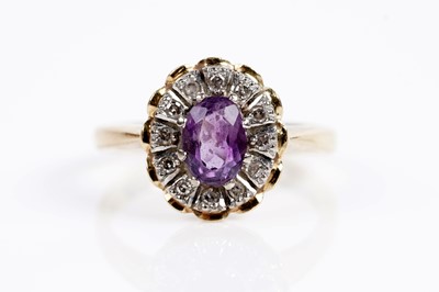 Lot 621 - An amethyst and diamond cluster dress ring