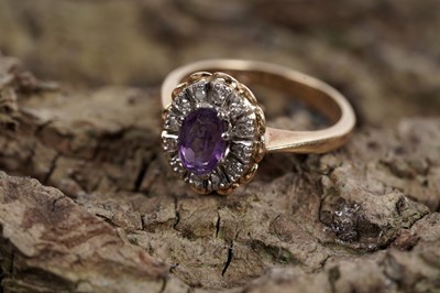Lot 621 - An amethyst and diamond cluster dress ring