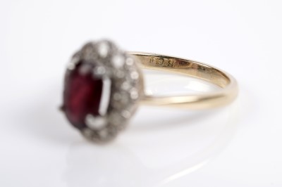 Lot 623 - A garnet and diamond cluster ring; and a ruby and diamond ring
