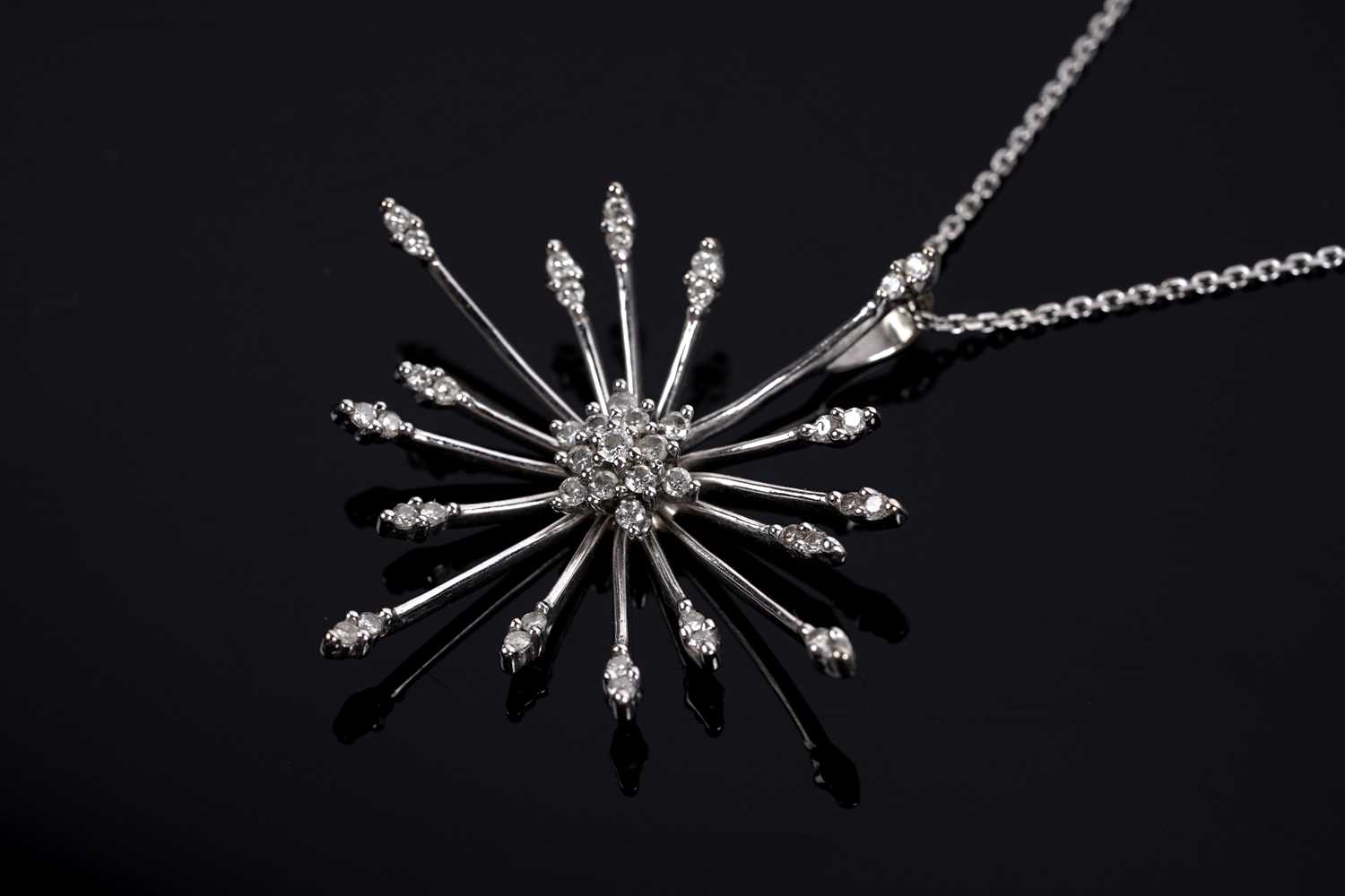 Lot 684 - A diamond cluster sunburst pendant necklace
