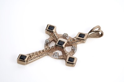 Lot 687 - A sapphire and diamond crucifix pendant and a garnet crucifix pendant