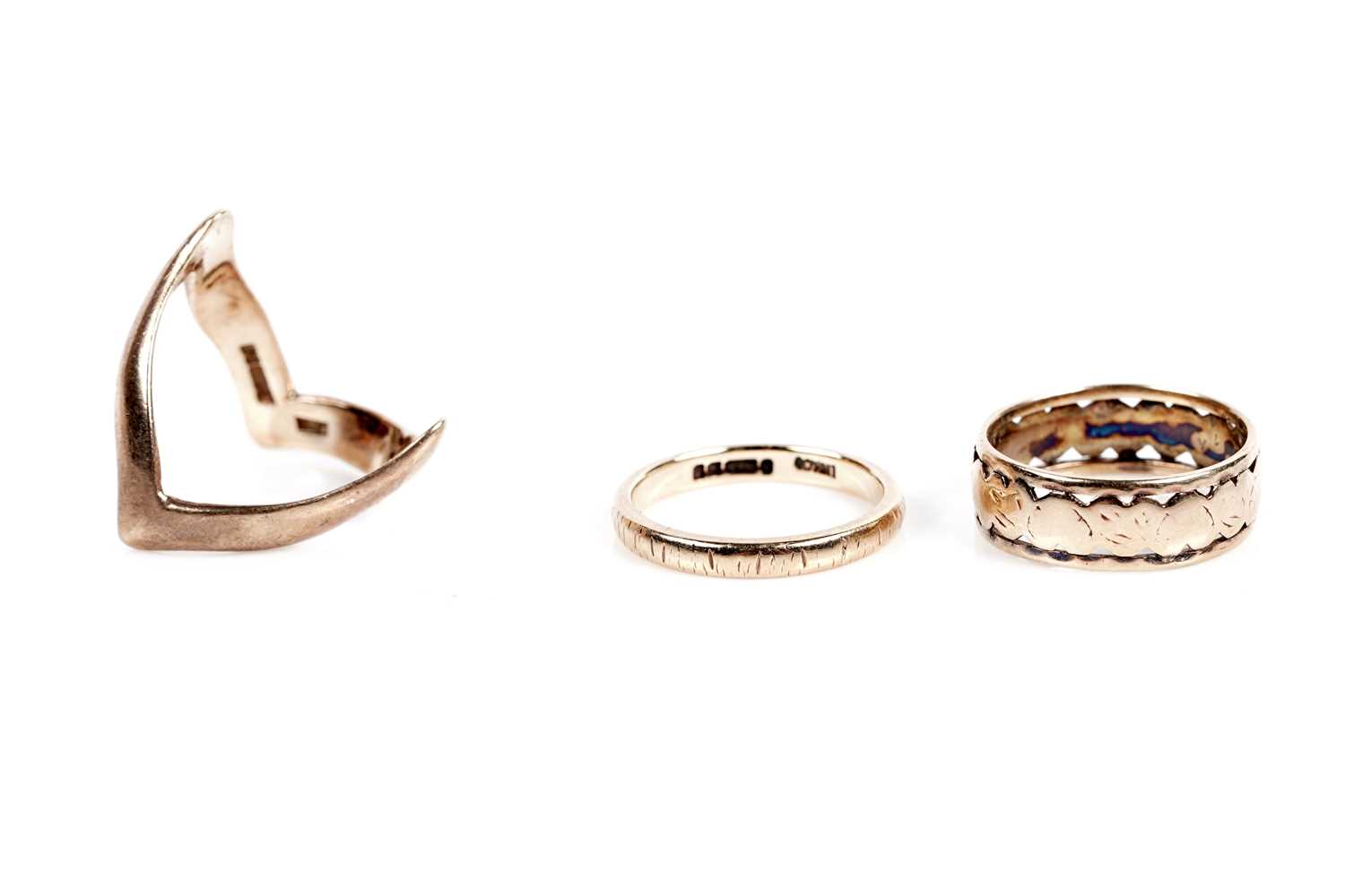 Lot 634 - Two gold wedding bands; and a wishbone band
