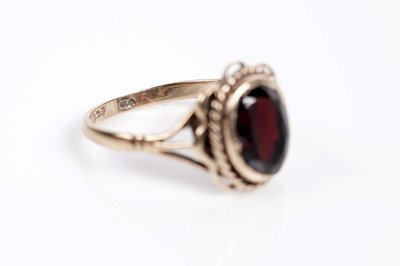 Lot 625 - A smoky quartz cocktail ring; and a garnet single stone ring