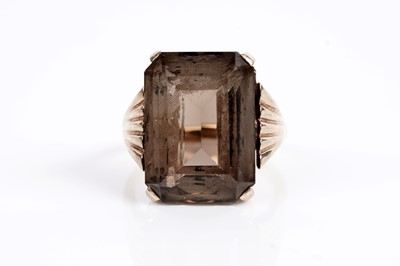 Lot 625 - A smoky quartz cocktail ring; and a garnet single stone ring