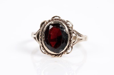 Lot 625 - A smoky quartz cocktail ring; and a garnet single stone ring