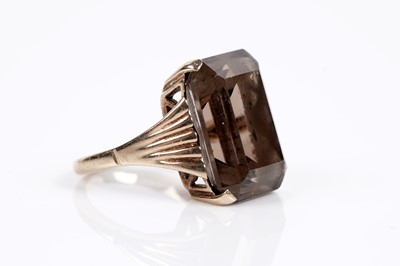 Lot 625 - A smoky quartz cocktail ring; and a garnet single stone ring