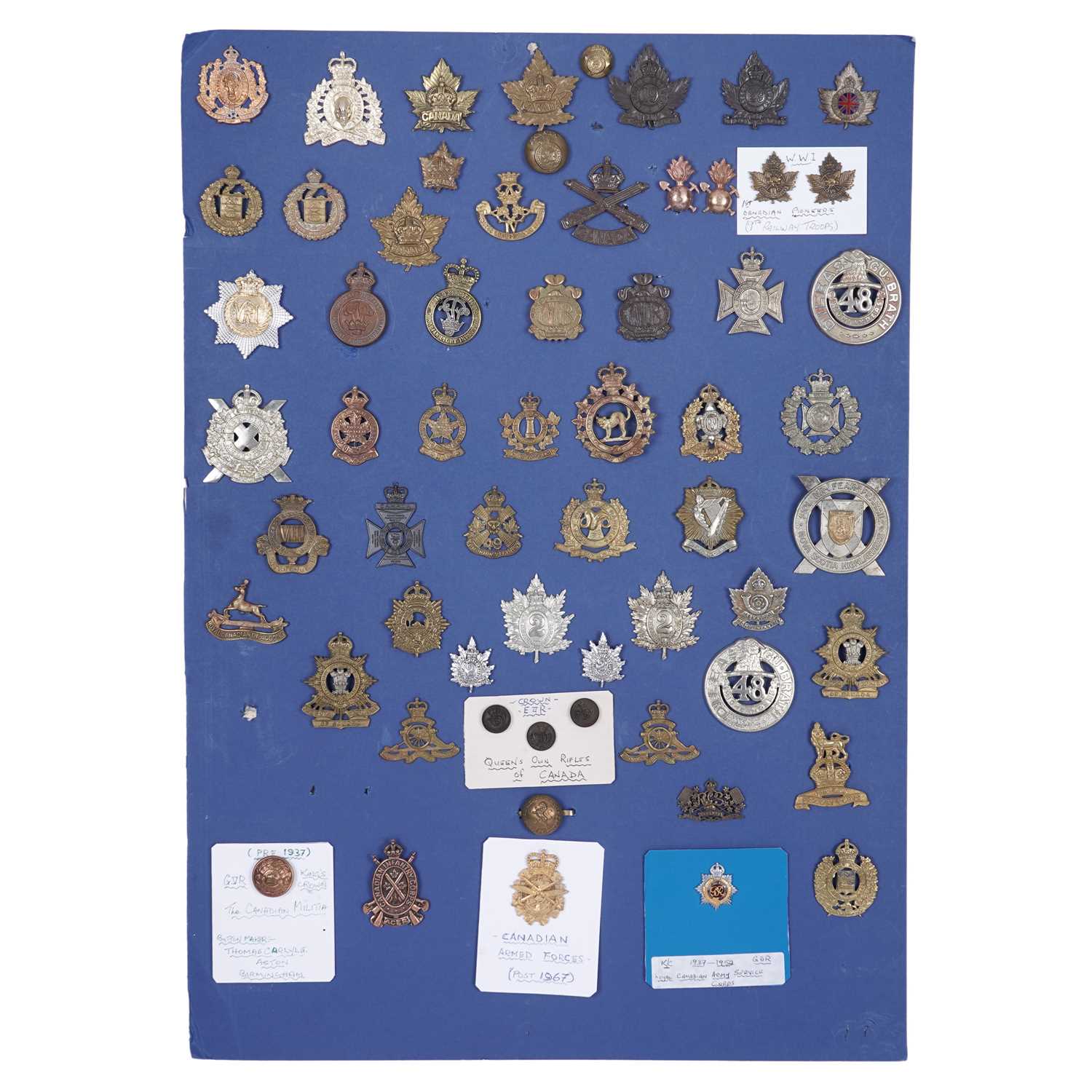 Lot 81 - A display of Canadian interest regimental cap badges and other items