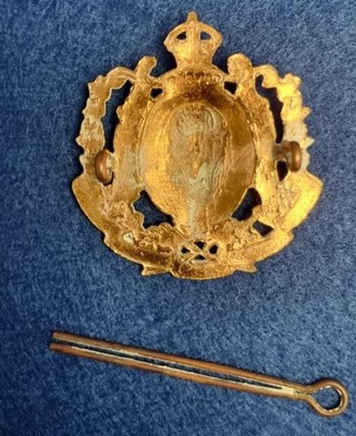 Lot 81 - A display of Canadian interest regimental cap badges and other items