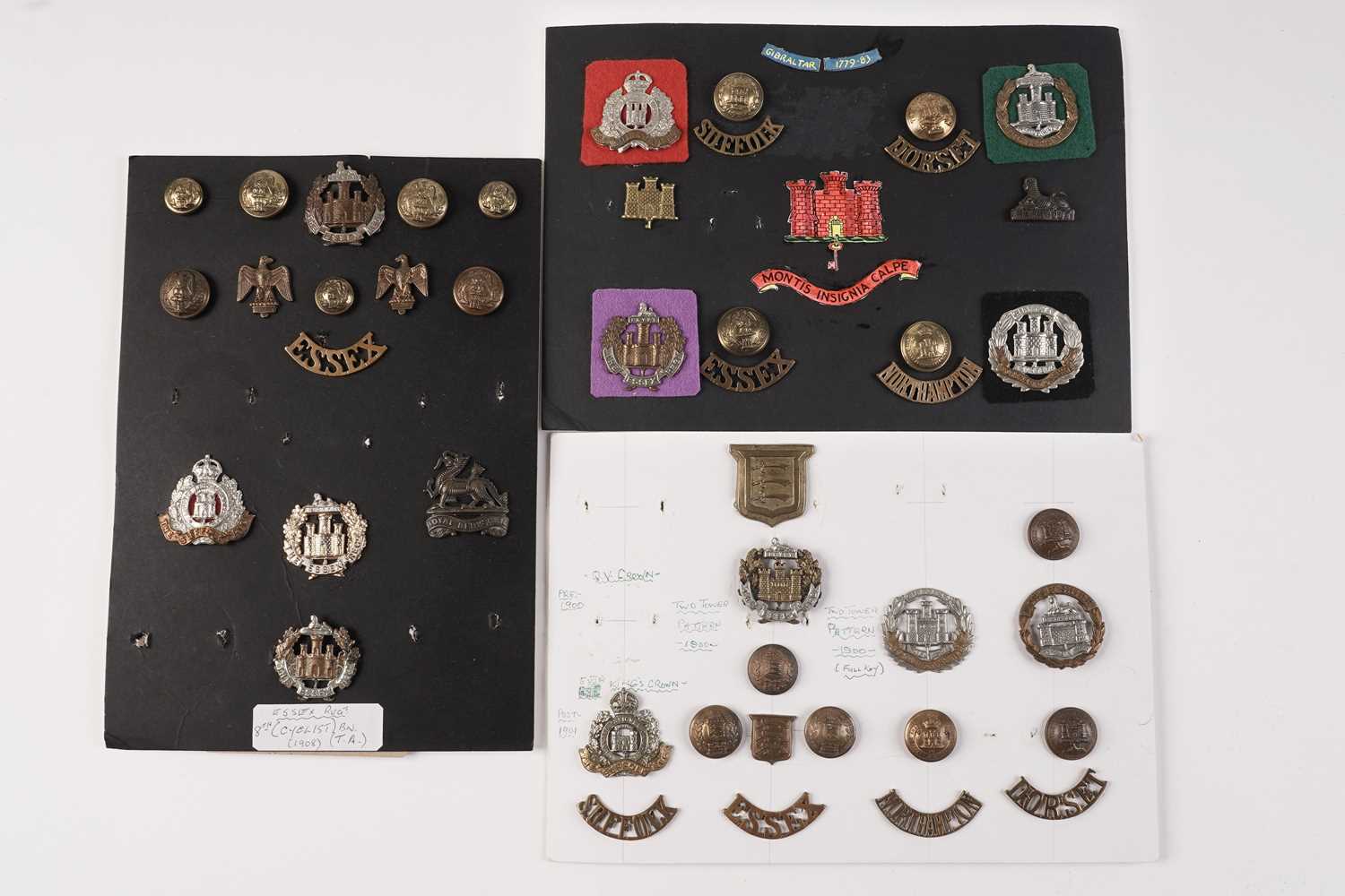Lot 89 - Three displays of cap badges, collar badges, buttons and titles