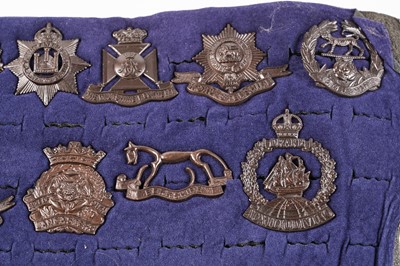 Lot 111 - A display of late pattern British regimental cap badges