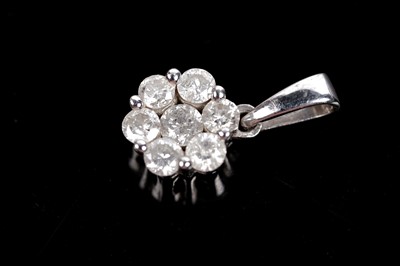 Lot 689 - A diamond flower cluster pendant and earring set