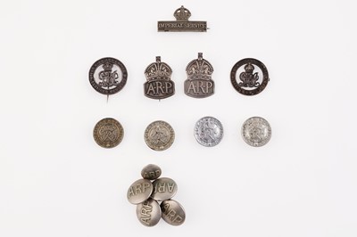 Lot 187 - Two silver Air Raid Patrol lapel badges; and various other badges/buttons