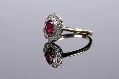 Lot 556 - A ruby and diamond flowerhead pattern ring
