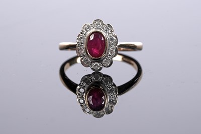 Lot 556 - A ruby and diamond flowerhead pattern ring
