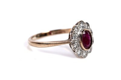 Lot 556 - A ruby and diamond flowerhead pattern ring