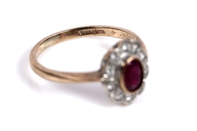 Lot 556 - A ruby and diamond flowerhead pattern ring