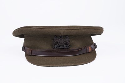 Lot 332 - ﻿﻿A selection of British military berets with badges; and an army officers peaked cap