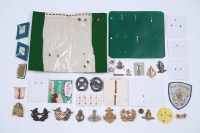 Lot 200 - A selection of foreign and commonwealth military cap badges, buttons and other items