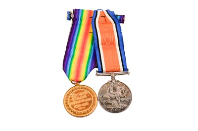 Lot 216 - A pair of First World War general service medals; and two cap badges