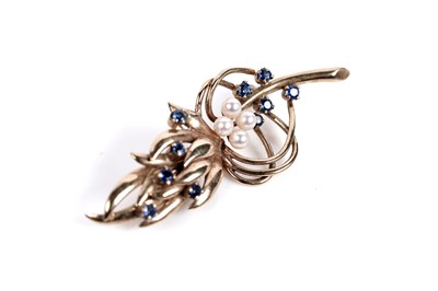 Lot 518 - A sapphire and pearl stylized sprig brooch
