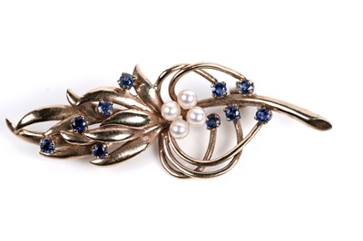 Lot 518 - A sapphire and pearl stylized sprig brooch