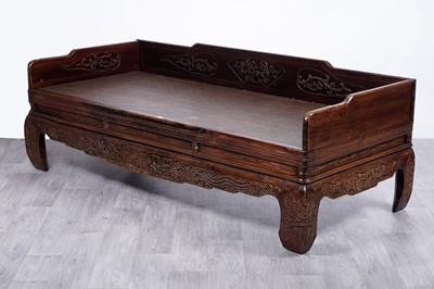Lot 112 - A substantial Chinese carved hardwood daybed