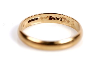 Lot 525 - A ruby and diamond ring; and an 18ct gold wedding band