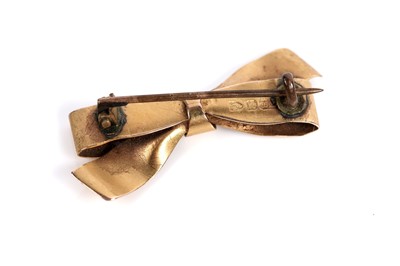 Lot 528 - Two brooches, one in the form of a bow, the other a berried sprig