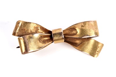 Lot 528 - Two brooches, one in the form of a bow, the other a berried sprig