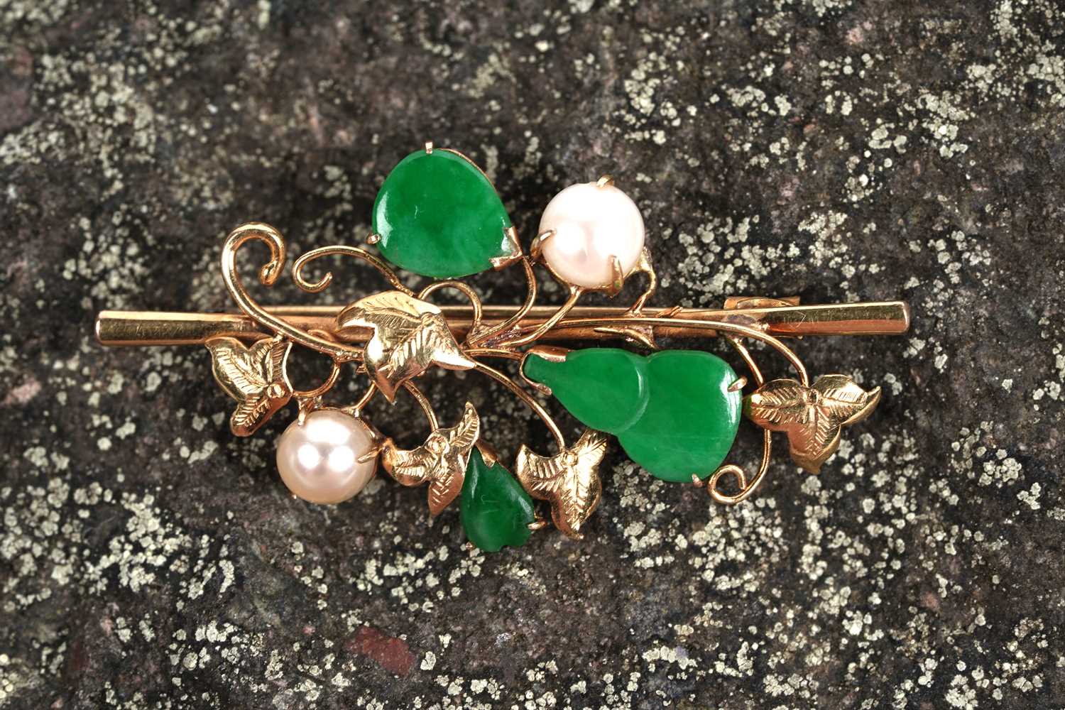Lot 543 - A jadeite and pearl foliate pattern brooch