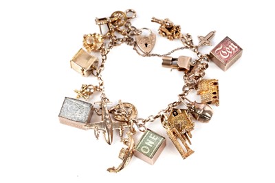 Lot 128 - A 9ct gold charm bracelet