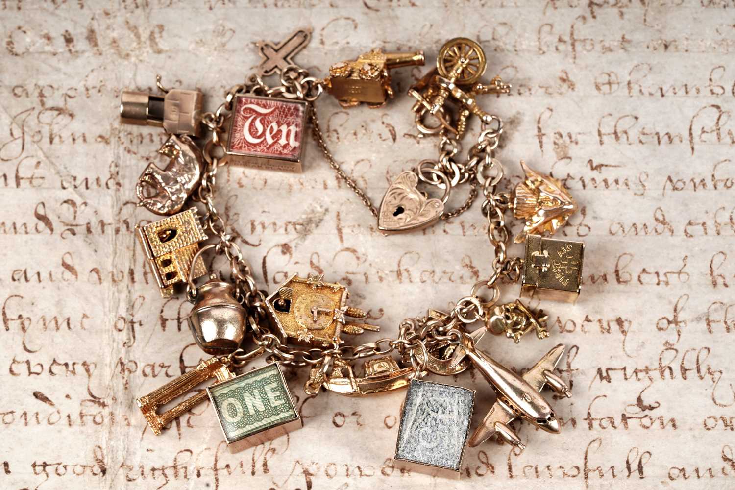 Lot 128 - A 9ct gold charm bracelet