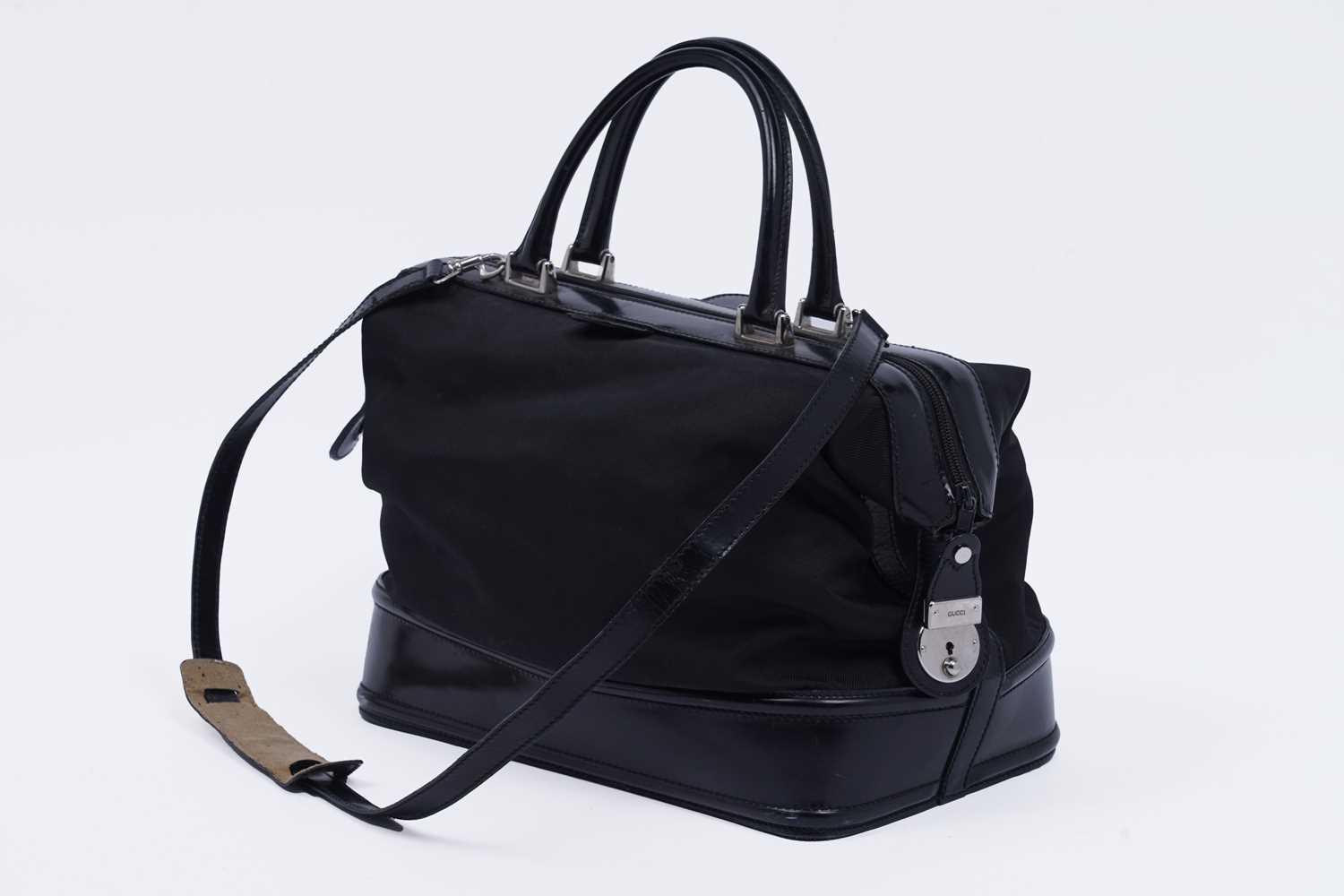 Lot 228 - A Gucci bag of black patent leather and canvas