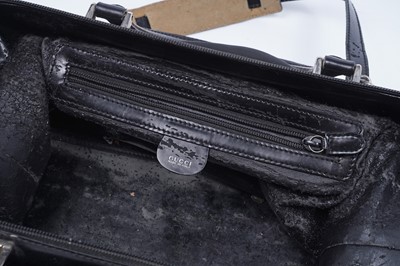 Lot 228 - A Gucci bag of black patent leather and canvas