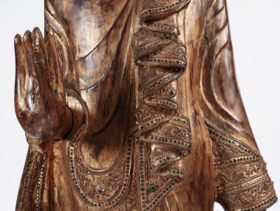 Lot 851 - A Burmese carved and giltwood 'jewelled' figure of Buddha