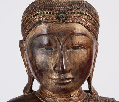 Lot 851 - A Burmese carved and giltwood 'jewelled' figure of Buddha
