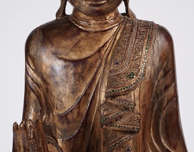 Lot 851 - A Burmese carved and giltwood 'jewelled' figure of Buddha