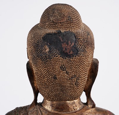 Lot 851 - A Burmese carved and giltwood 'jewelled' figure of Buddha
