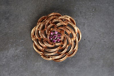 Lot 519 - An 18ct yellow gold and ruby flower pattern brooch